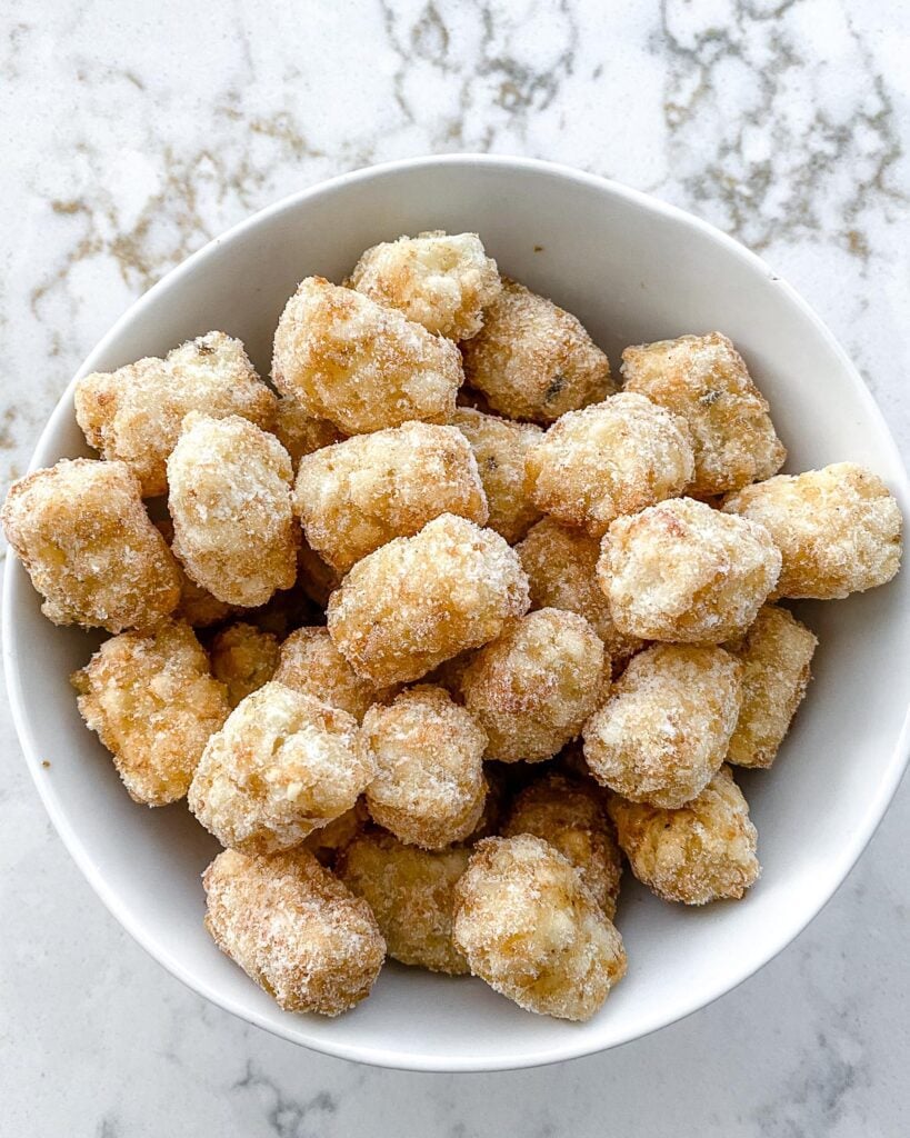 bowl of frozen tater tots in white bowl