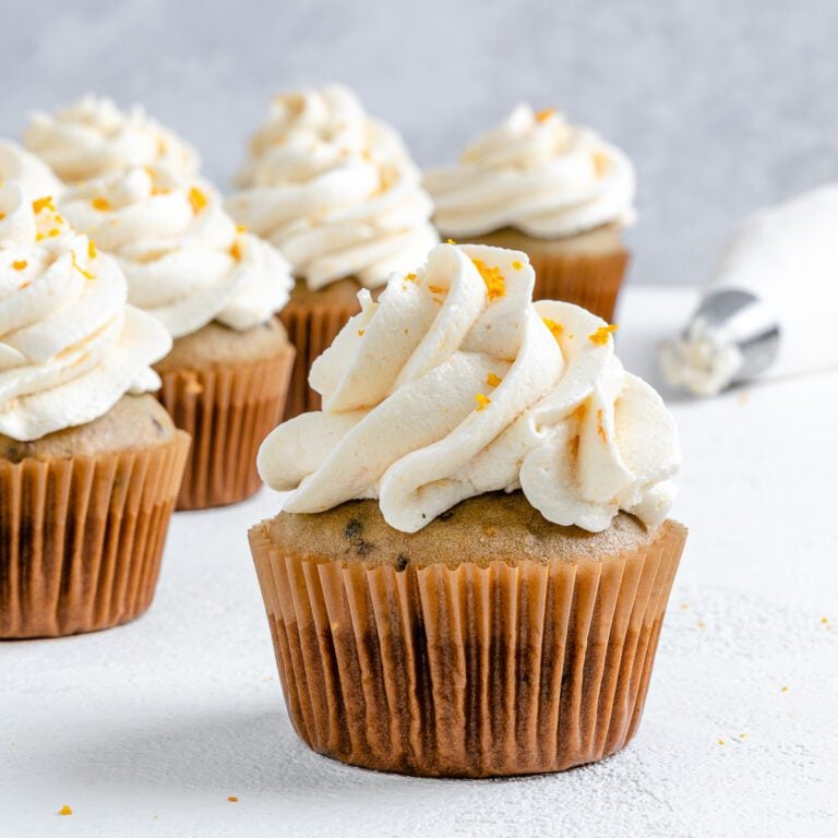 completed Blackberry Orange Cupcakes displayed on a white surface