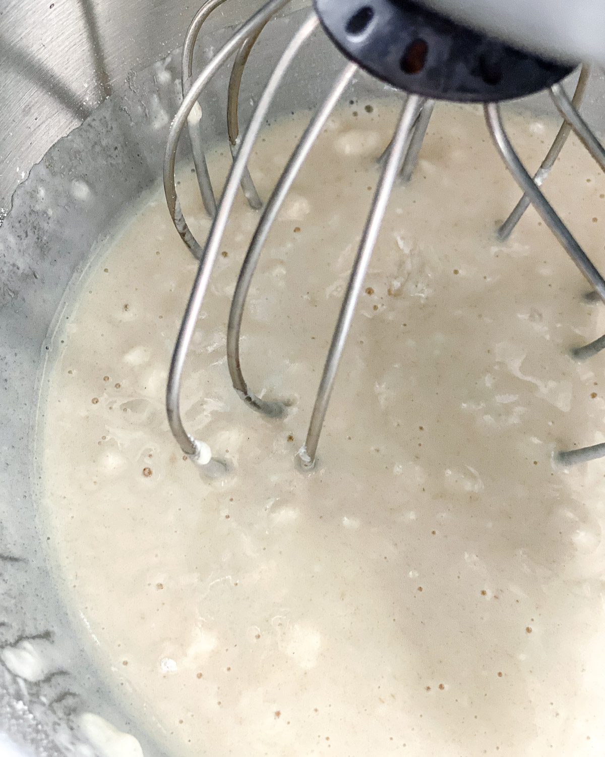 process of batter of Lemon Frosting Cake being mixed in mixing bowl