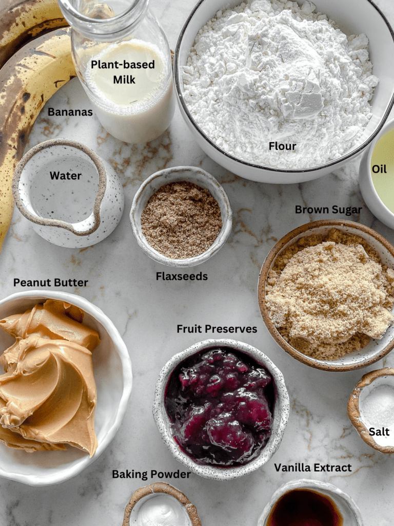Ingredients for Peanut Butter and Jelly Blondie Bars measured out on a white surface.