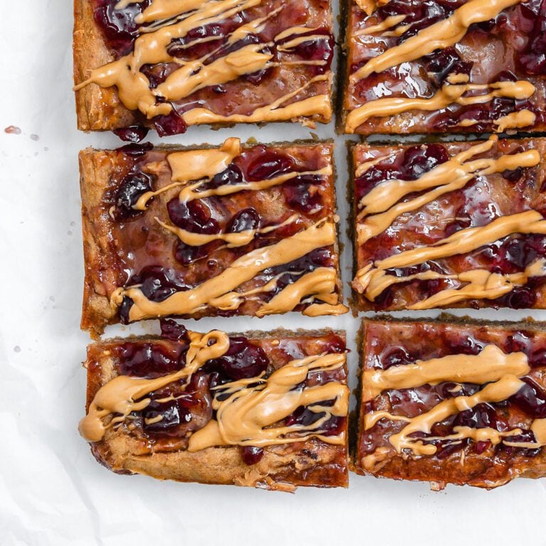 completed and sliced Peanut Butter and Jelly Blondie Bars on a white surface