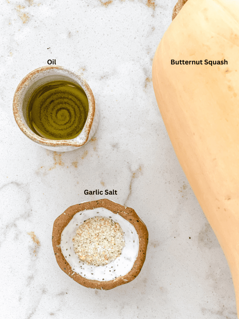 Ingredients for Air Fryer Butternut Squash measured out on a white surface.