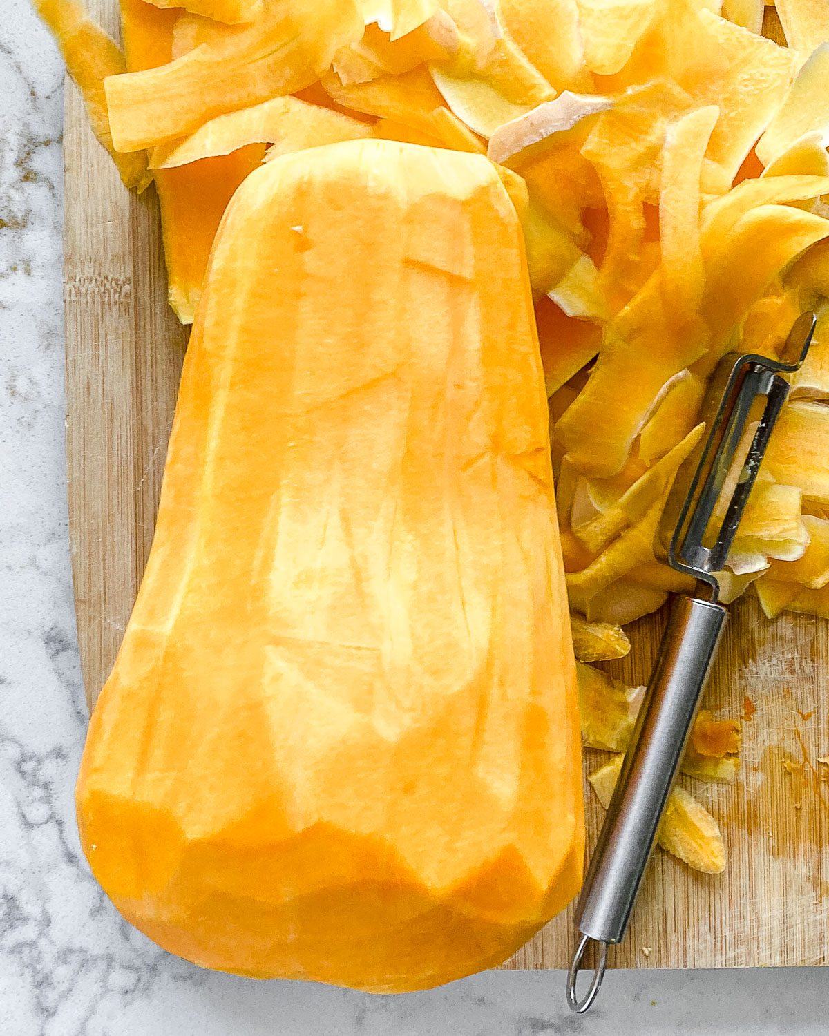 process showing post taking off the skin of a butternut squash