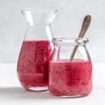 completed Blueberry Vinaigrette in two glass jars against a white background
