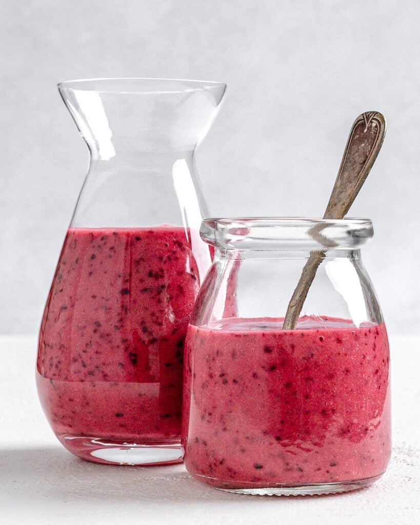 completed Blueberry Vinaigrette in two glass jars against a white background