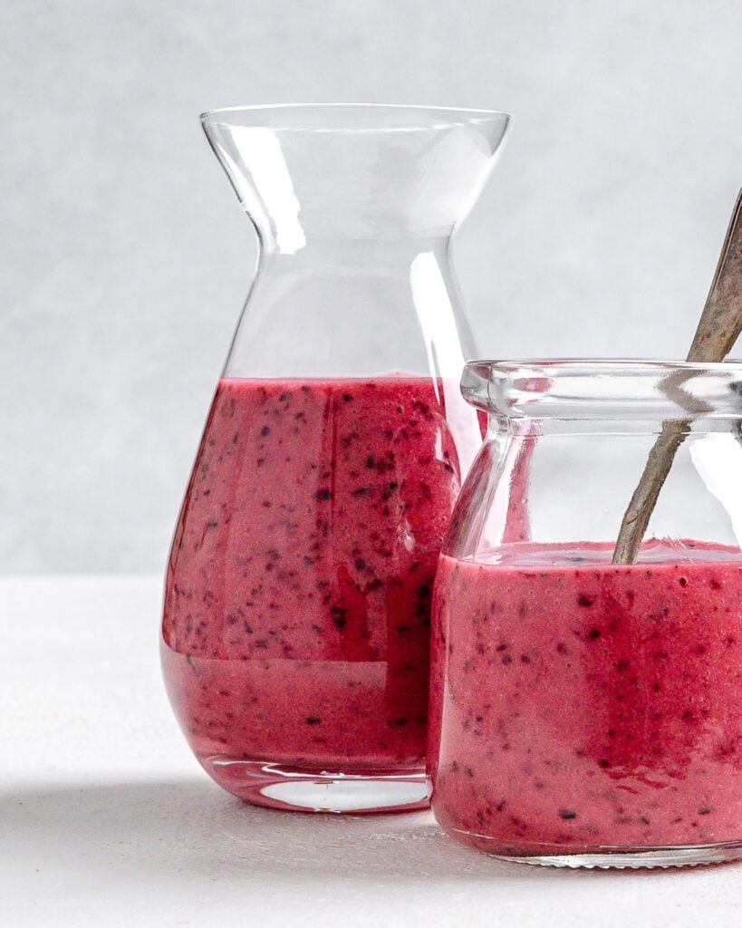 completed Blueberry Vinaigrette in two glass jars against a white background