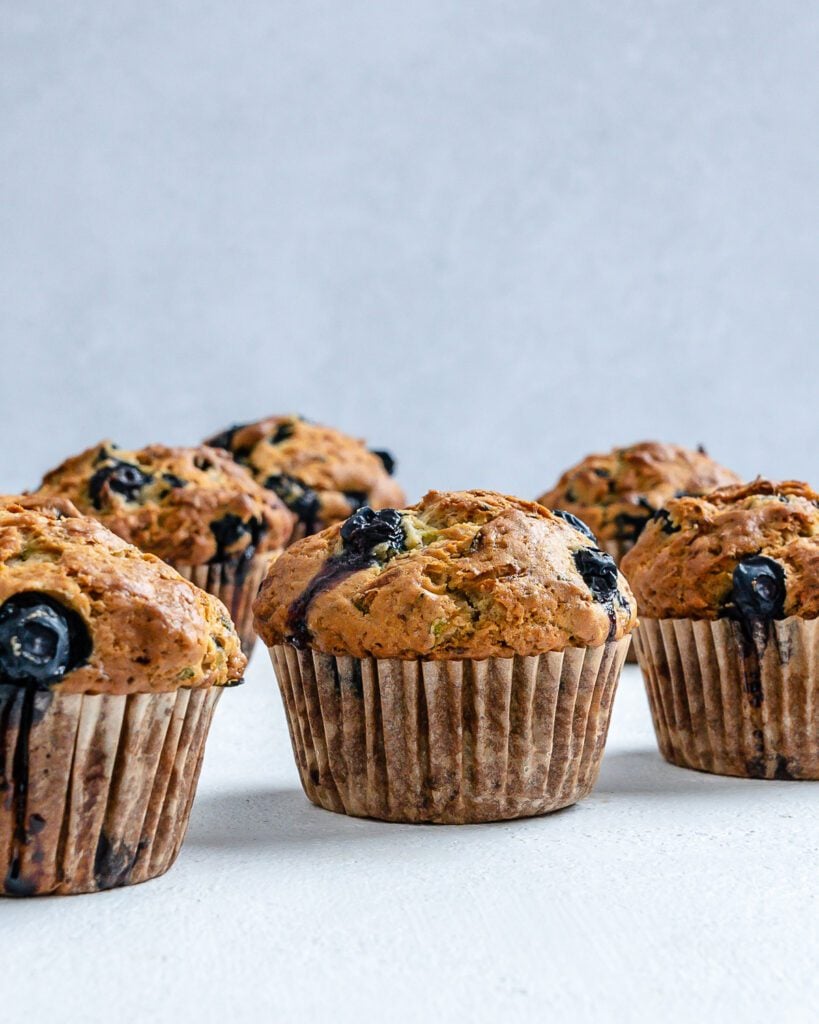 post cooked Blueberry Zucchini Muffins against a white background