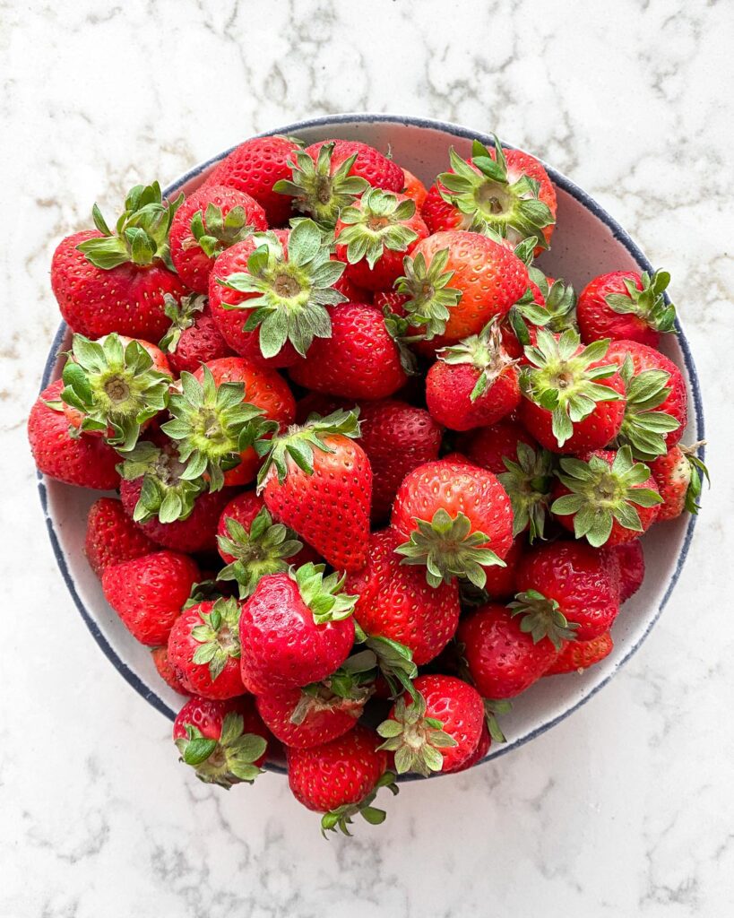 bowl of strawberries against a white background