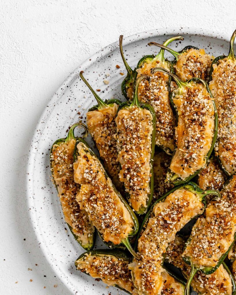 completed Vegan Jalapeno Poppers on a white speckled plate against a white background