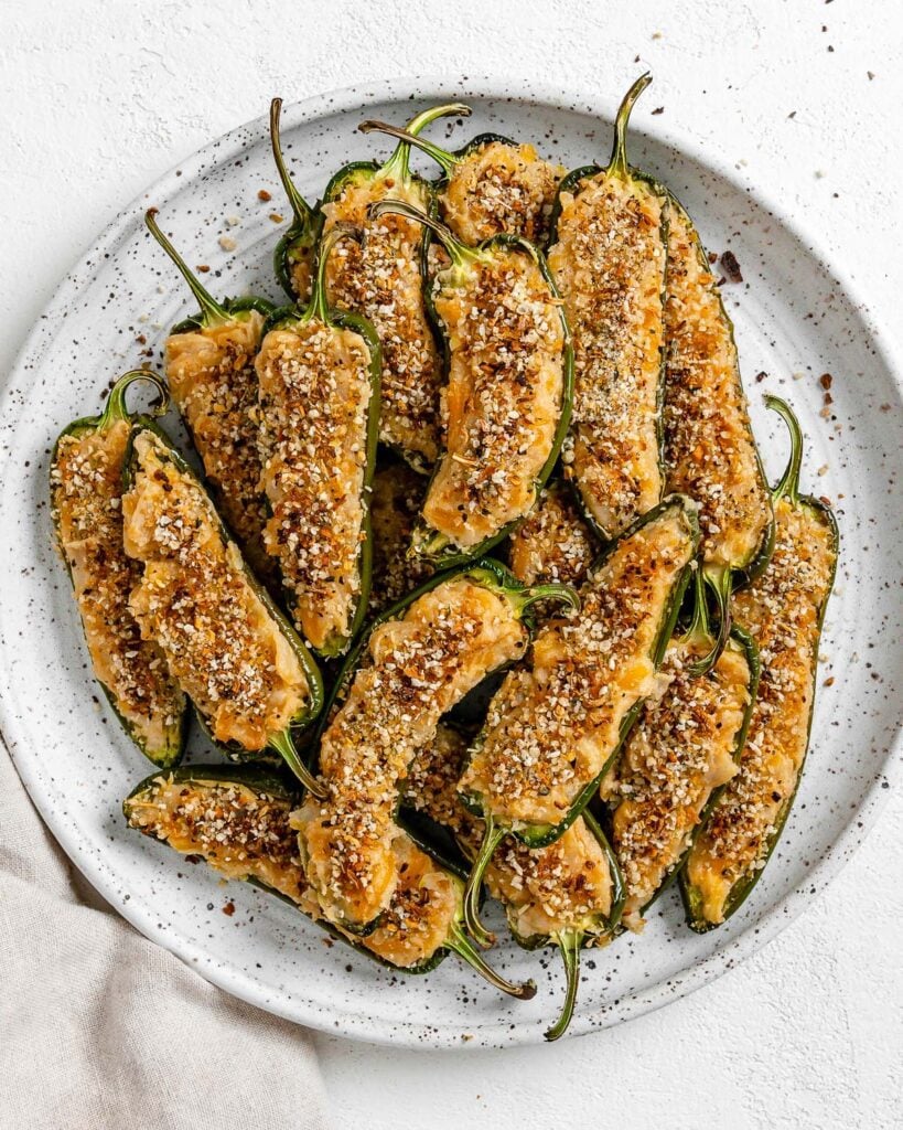 completed Vegan Jalapeno Poppers on a white speckled plate against a white background