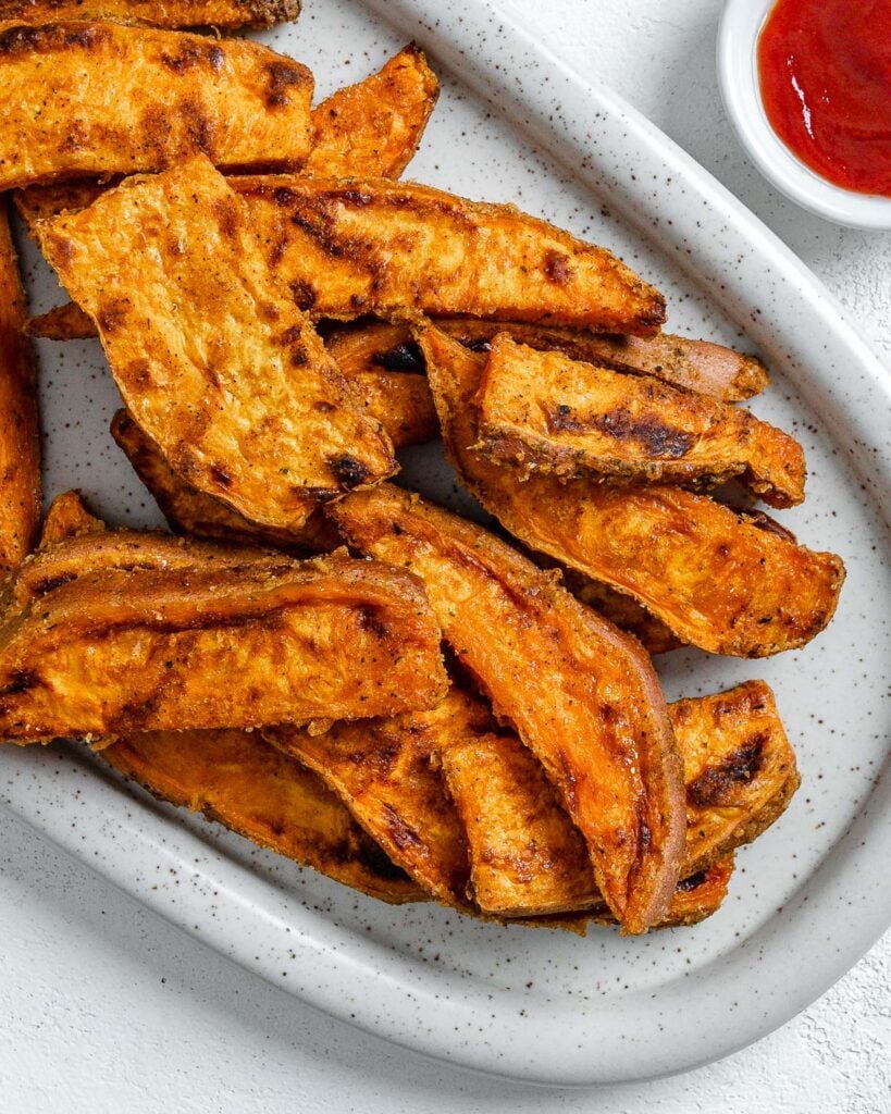 completed sweet potato wedges on a white platter