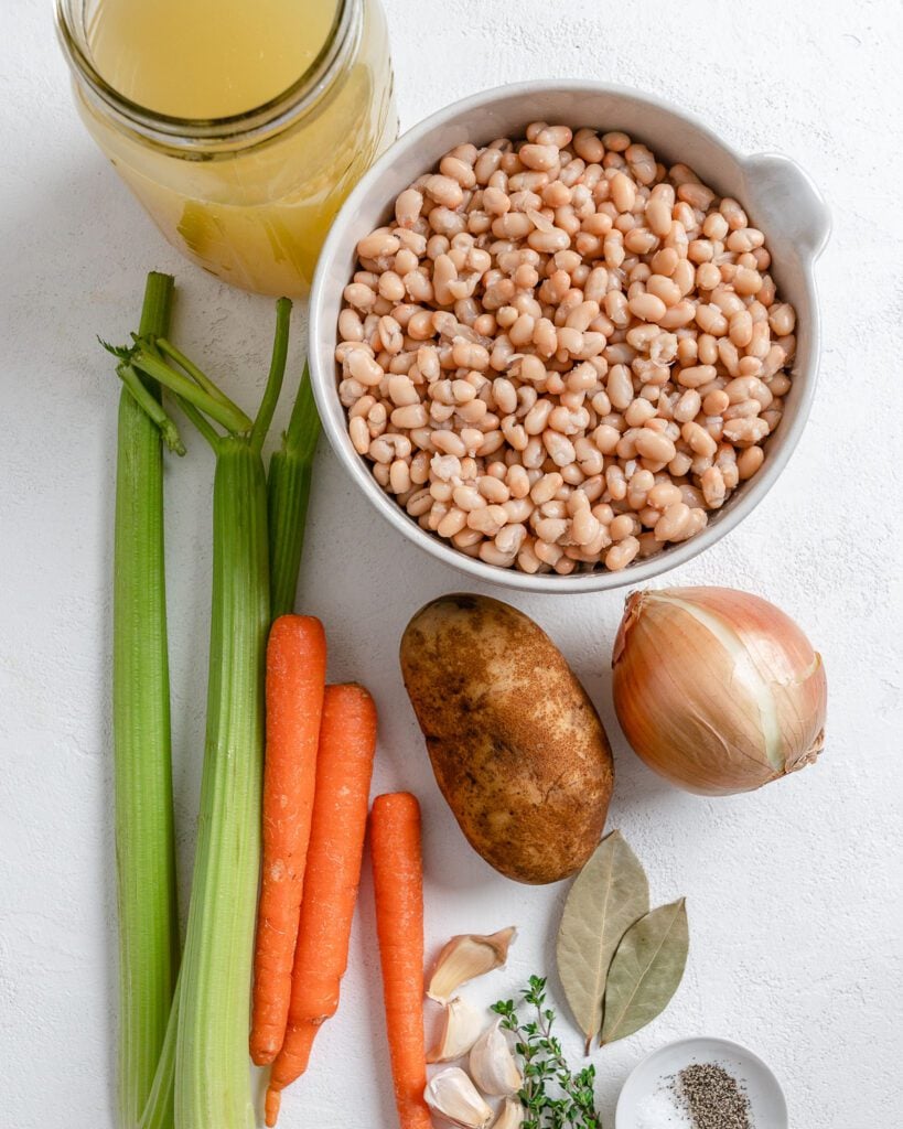 ingredients for Vegan Instant Pot Navy Bean Soup against a white surface