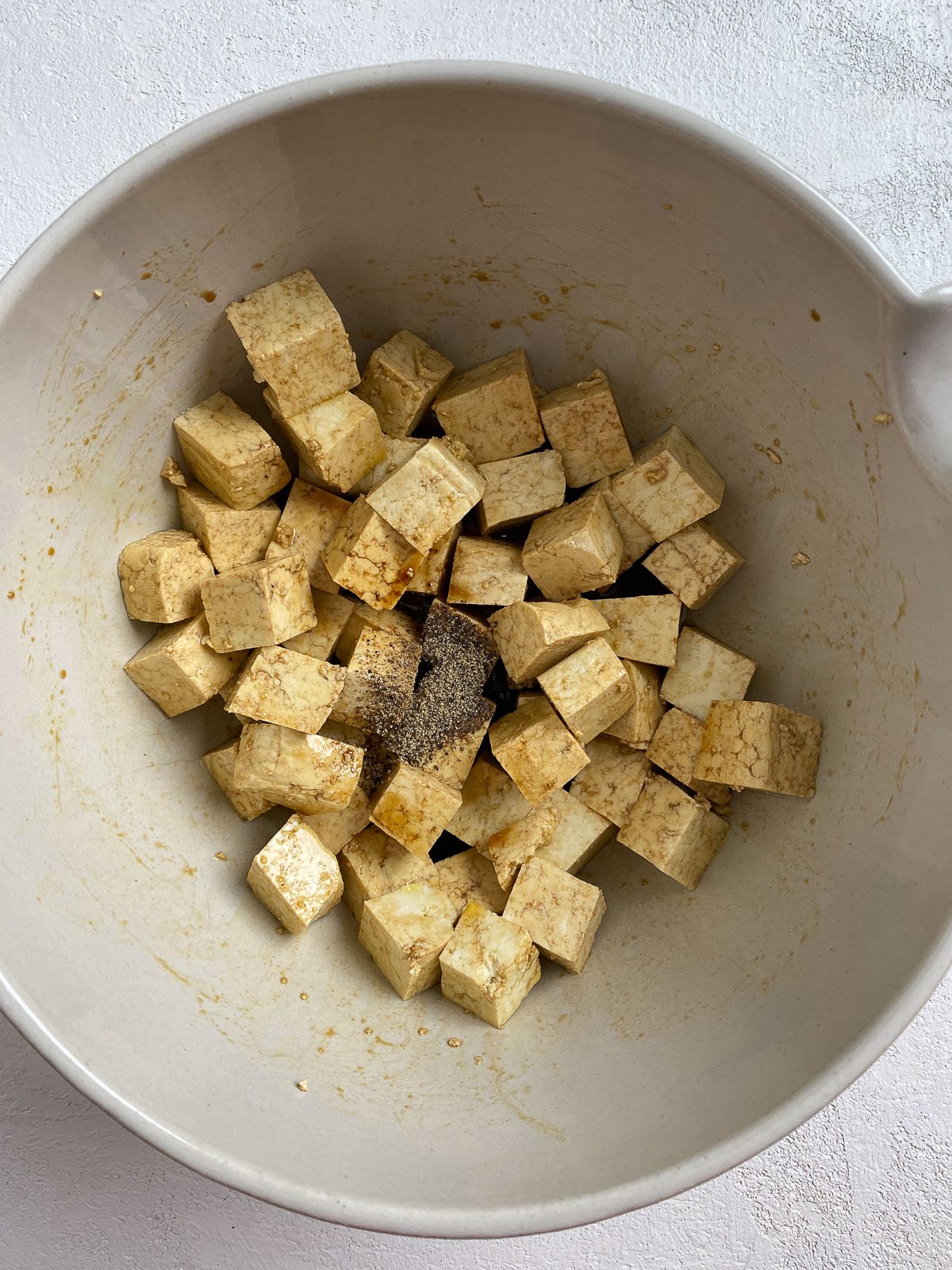 post mixing of soy sauce and oil in a white bowl