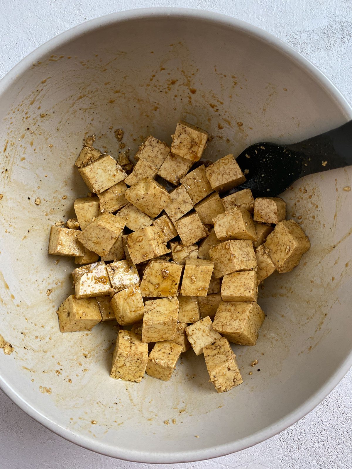 post mixing of soy sauce and oil in a white bowl