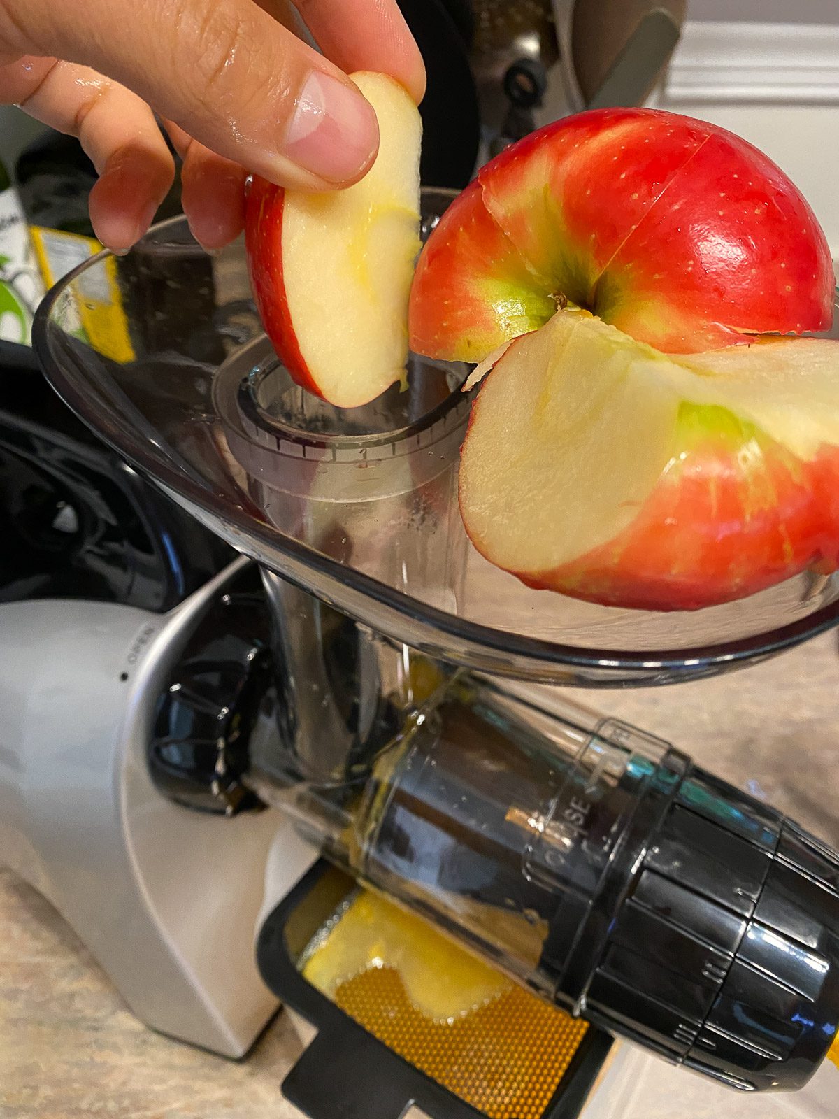 process shot of adding apples to juicer