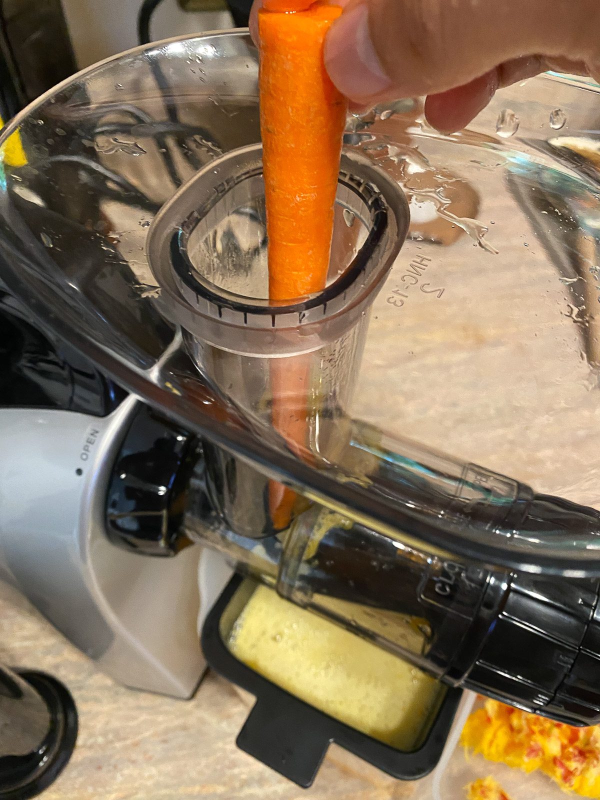 process shot of adding carrot to juicer