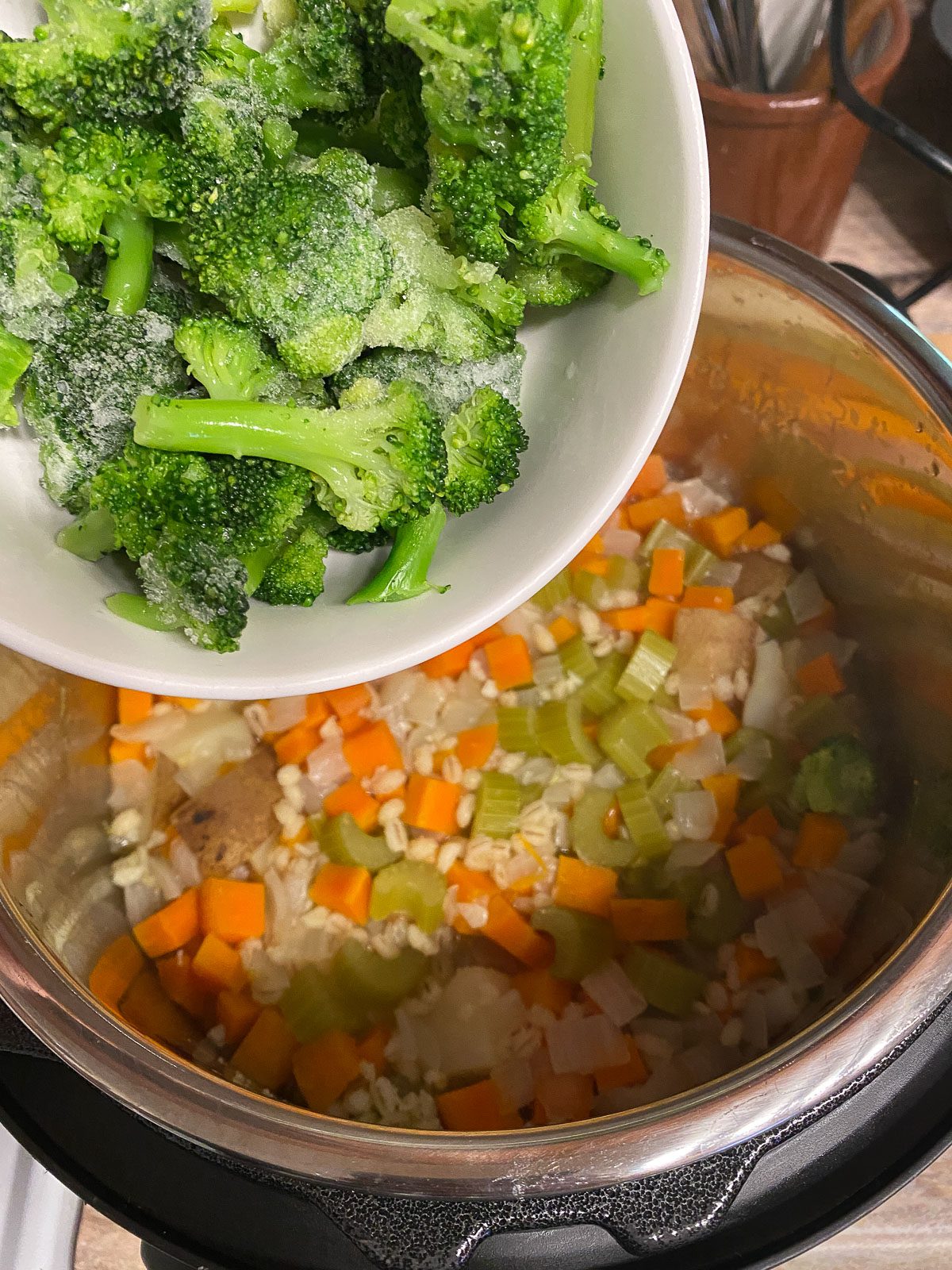 process shot of adding broccoli to instant pot