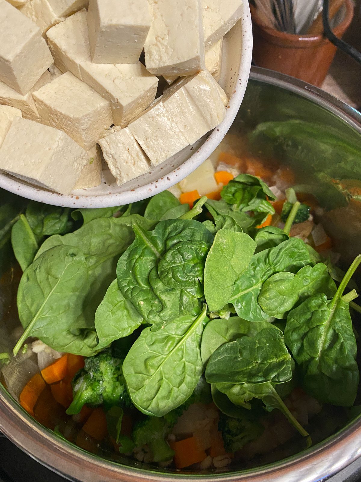 process shot of tofu being added to instant pot