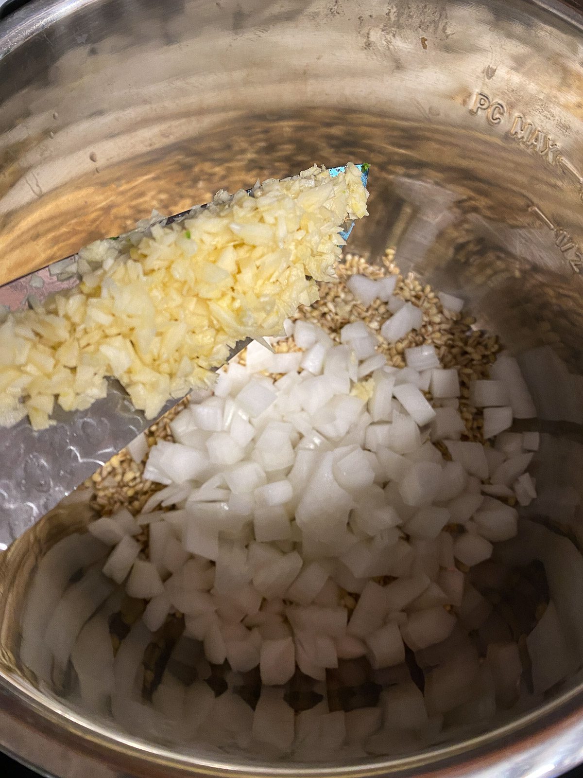 process shot showing the addition of garlic to instant pot