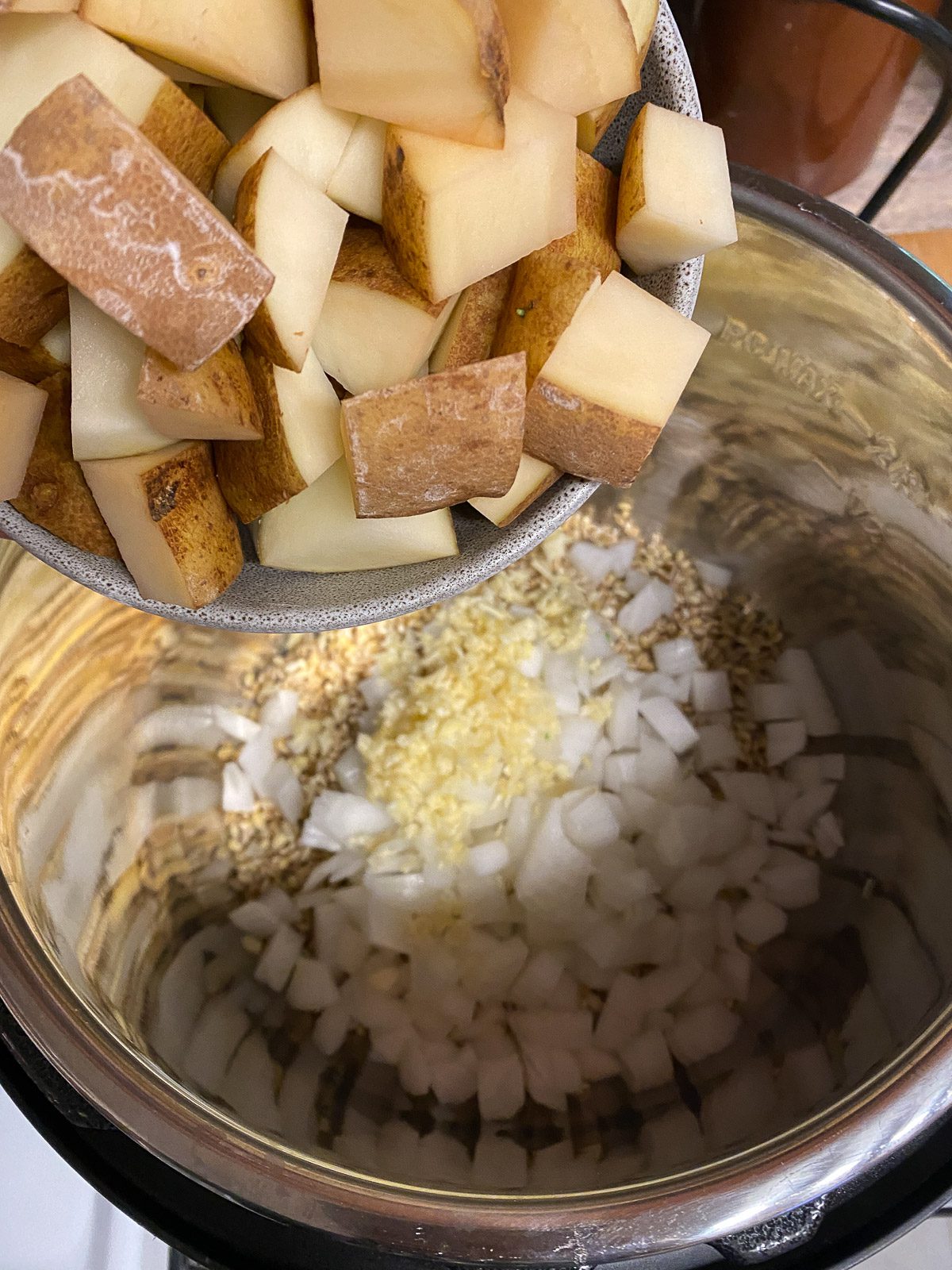 process shot of potatoes being added to instant pot