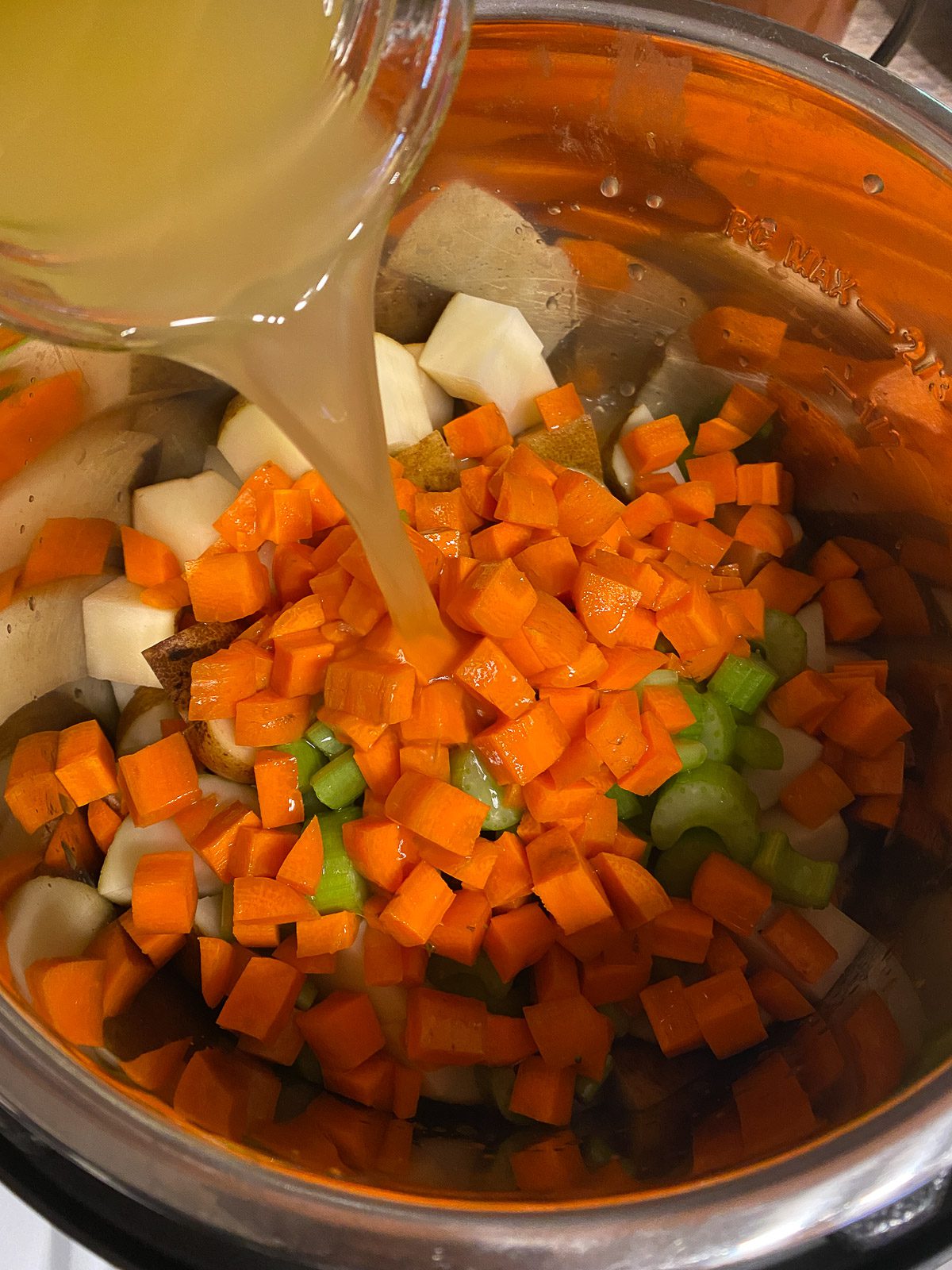 process shot of vegetable bouillon being added to instant pot