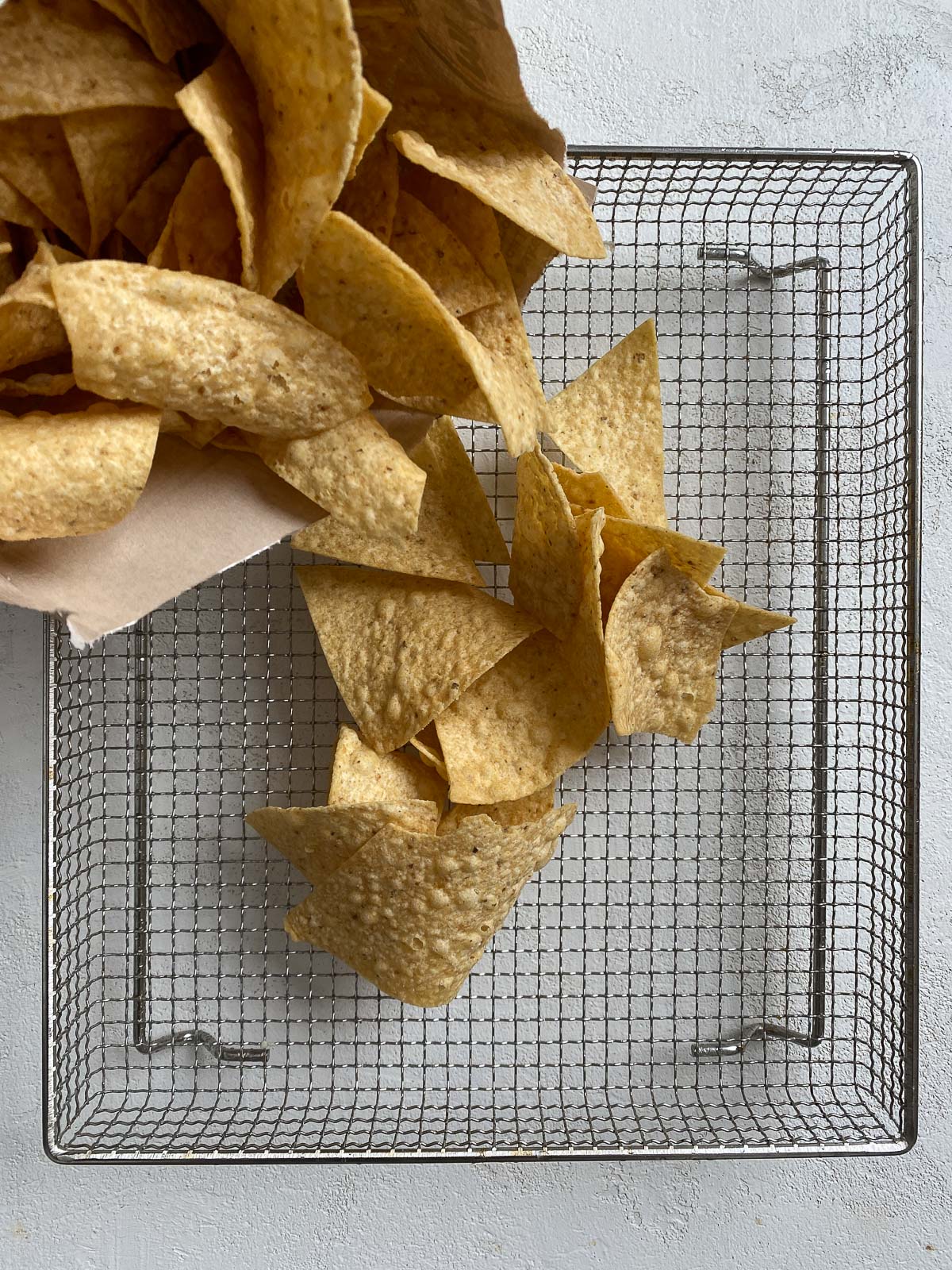 chips being poured onto air fryer rack