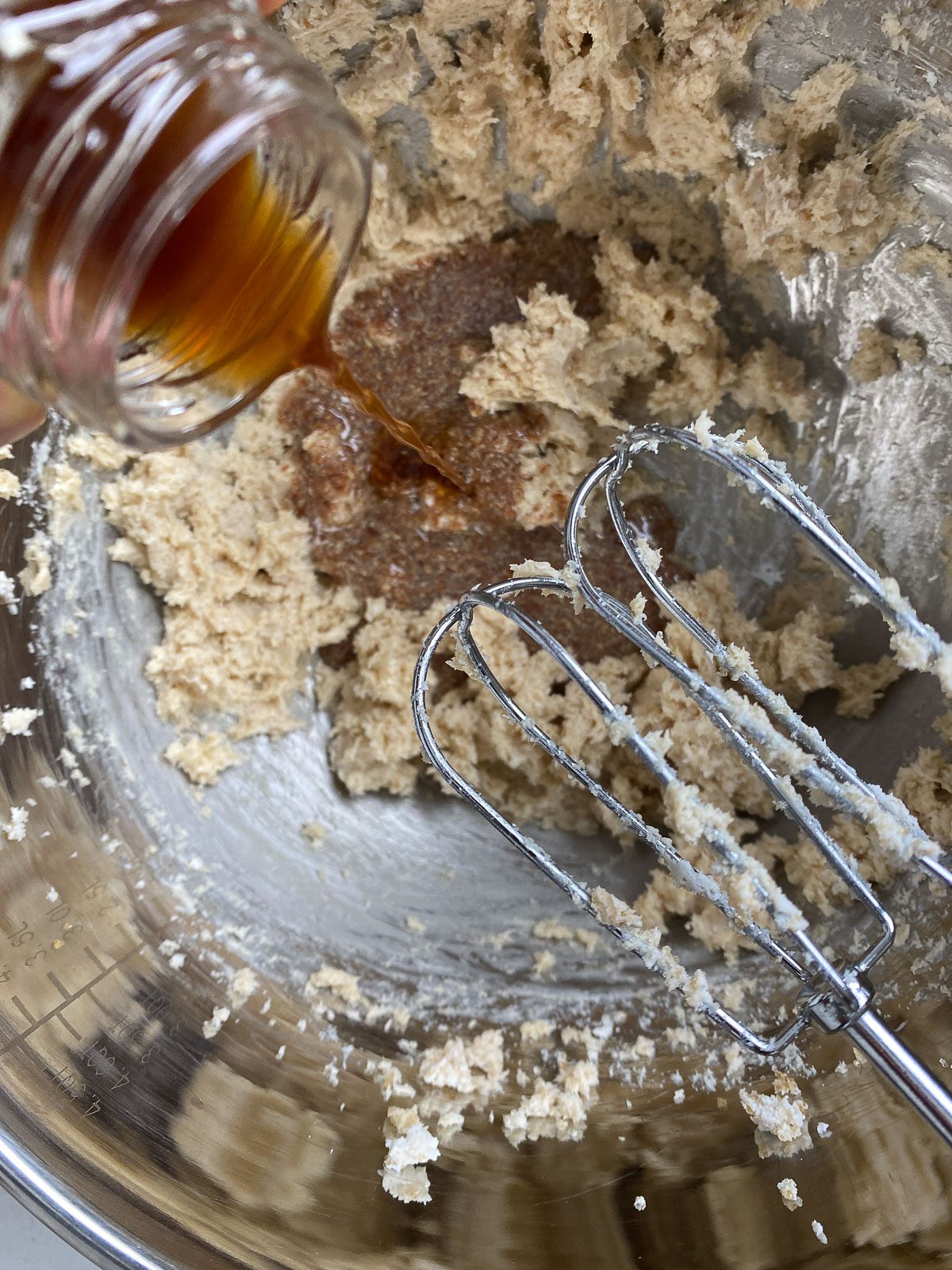 process of adding vanilla to mixing bowl