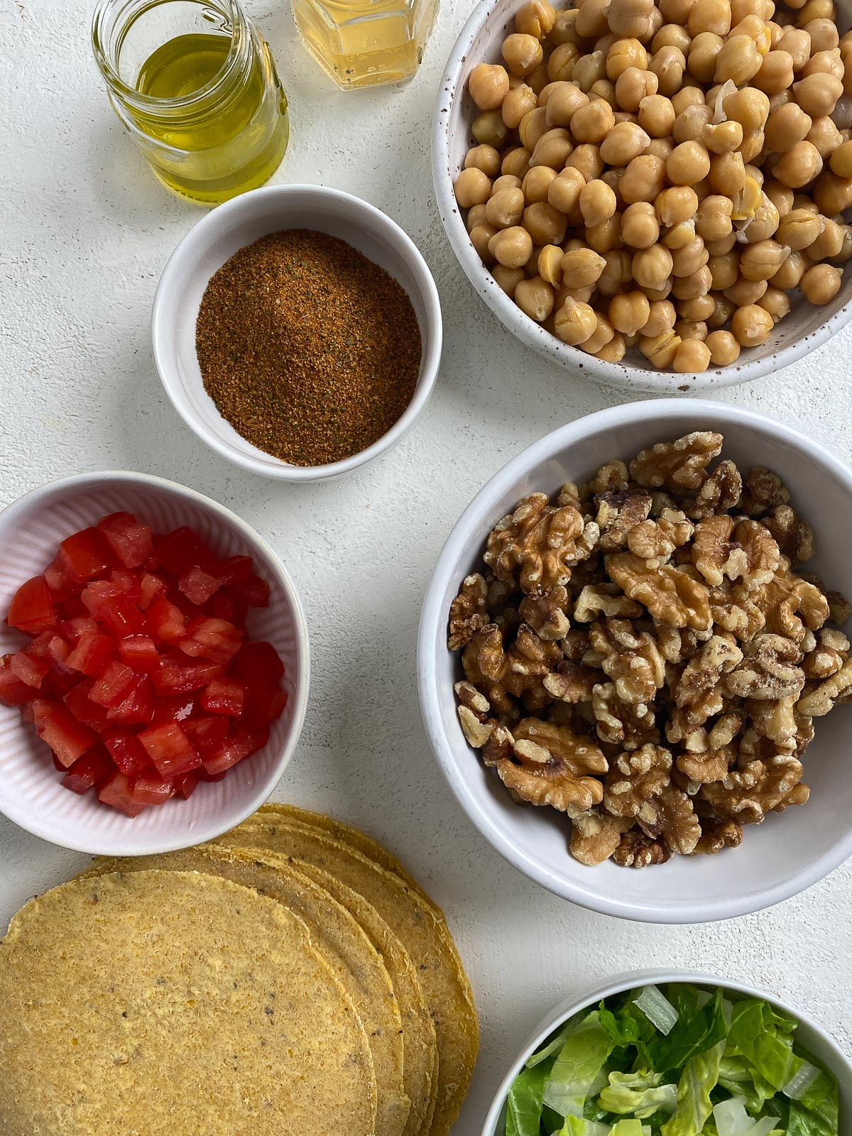 separate bowls of ingredients for chorizo tacos against a white background