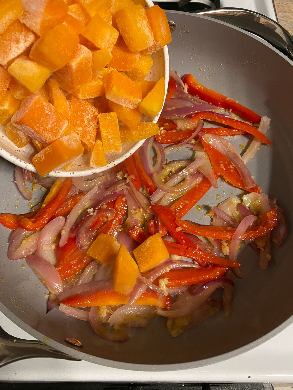 process of adding butternut squash to skillet