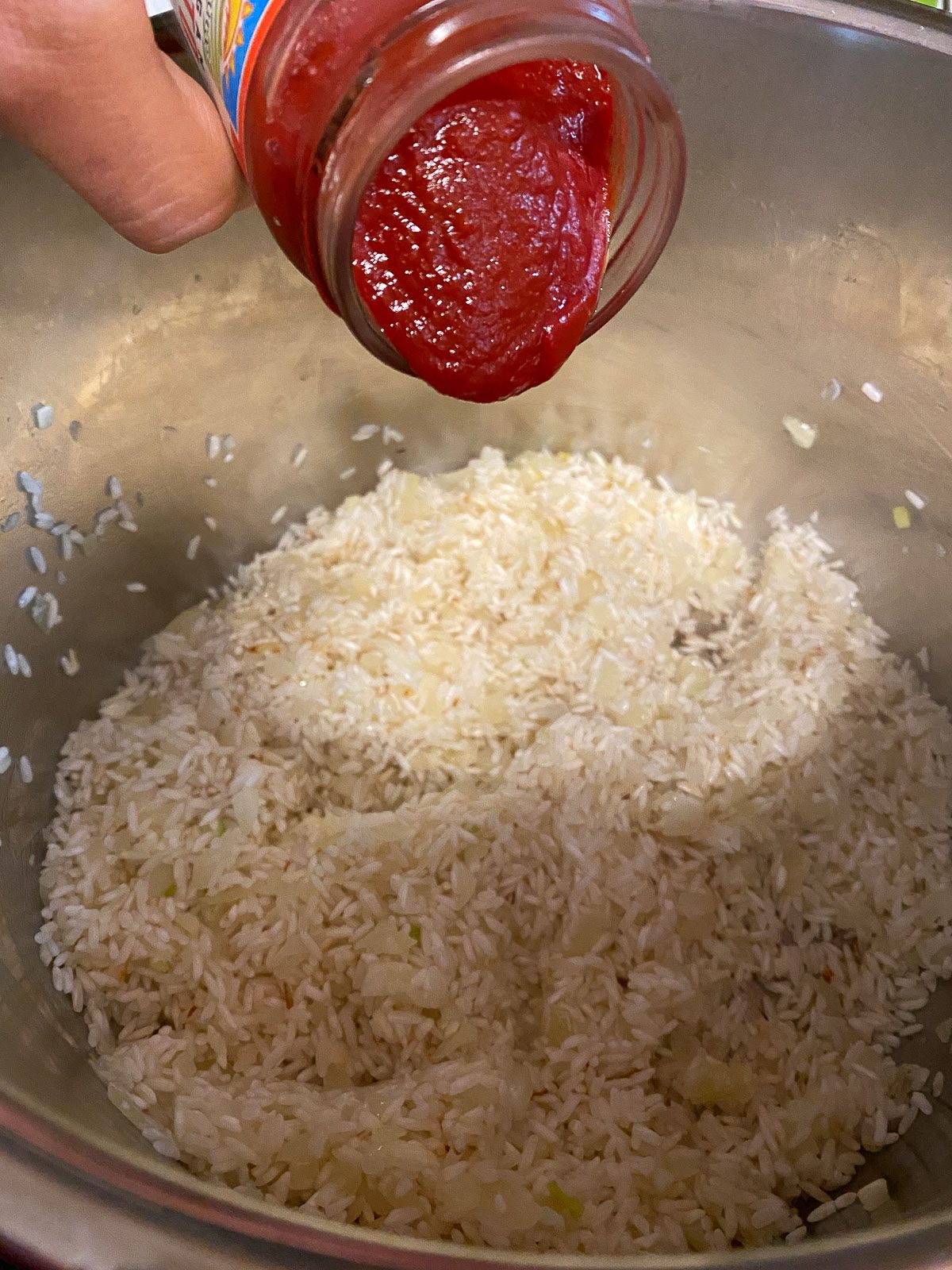process of adding tomatoes to pot