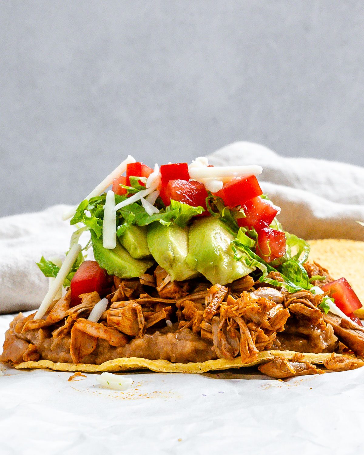 completed Vegan Jackfruit Tostadas on a white surface