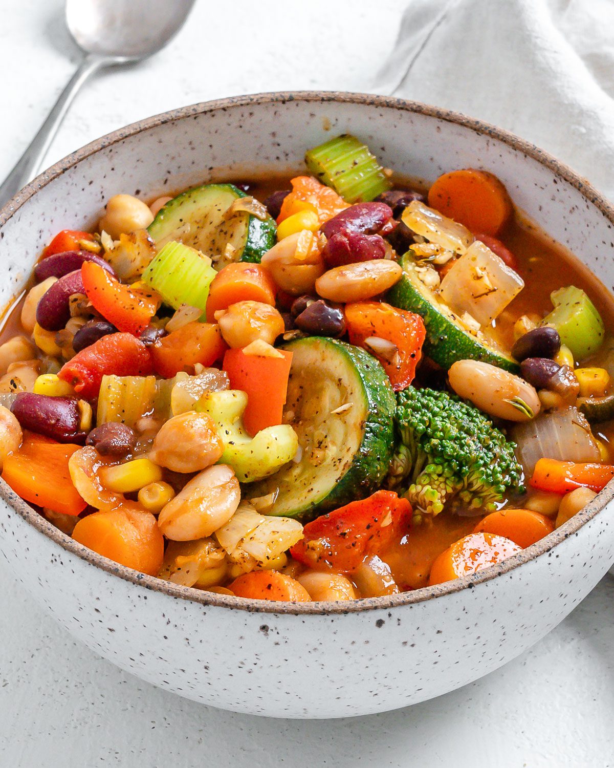 completed vegetable stew in a white bowl against a white surface