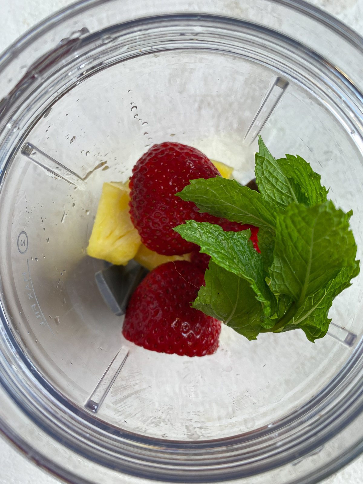 ingredients for Strawberry Pineapple Mocktail added to blender