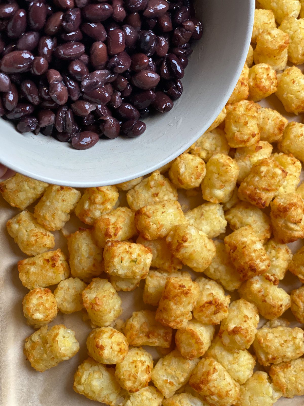 process of adding beans to tater tots
