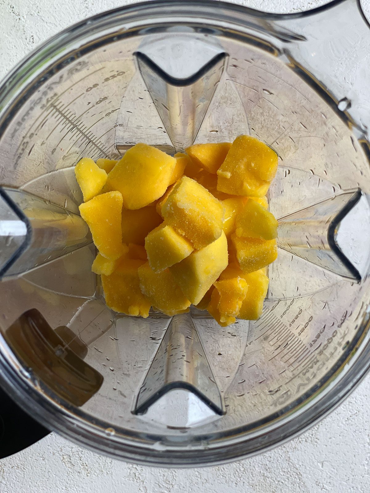process of adding mangos to food processor
