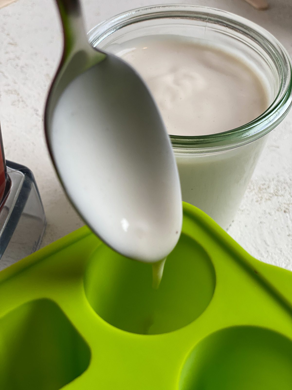 process of adding vegan yogurt to popsicle mold