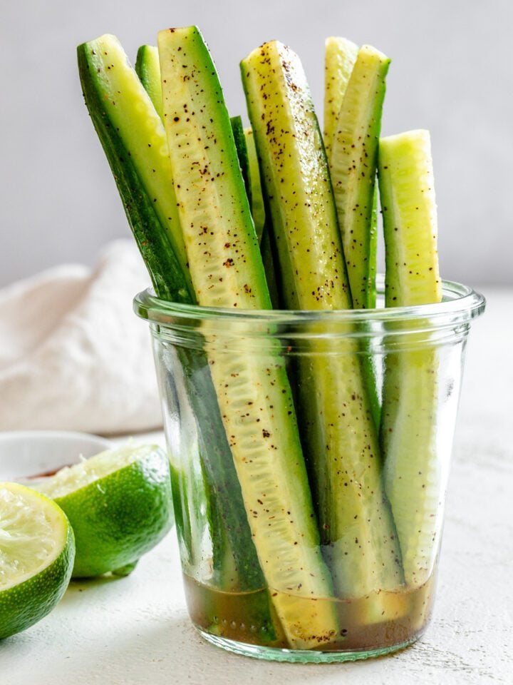 completed Cucumbers with Tajin in a clear glass against a light background