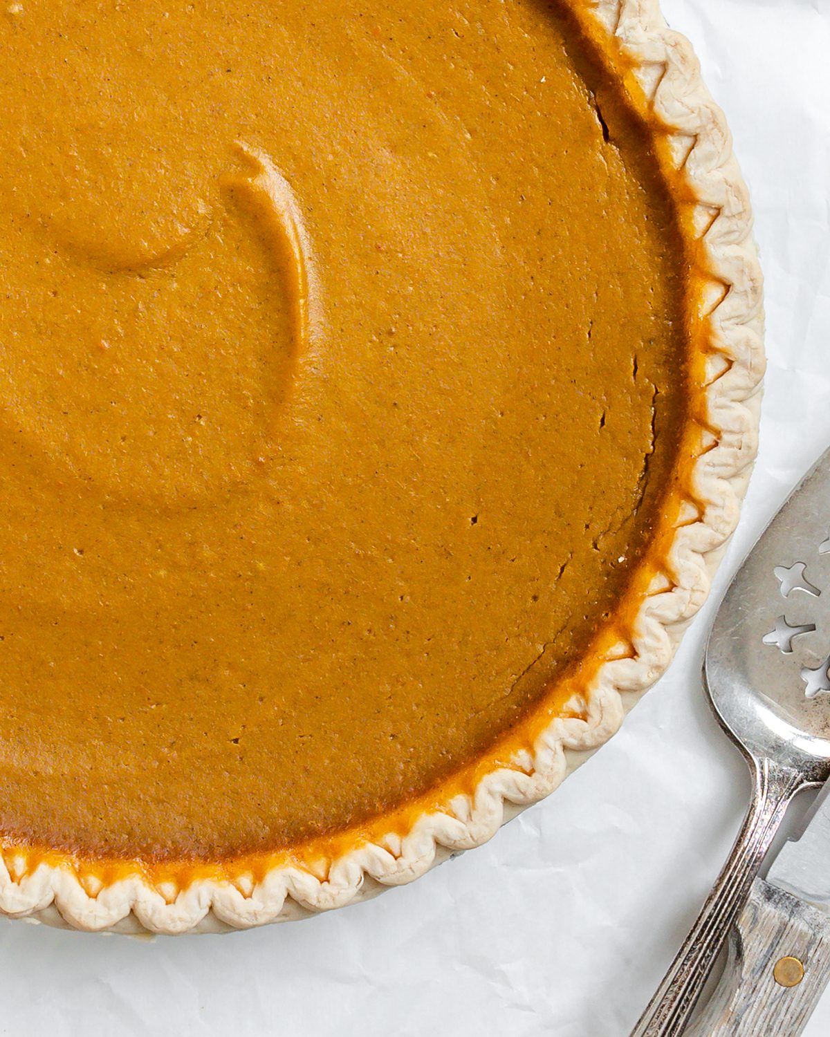 completed post baked Easy Vegan Pumpkin Pie against a white surface