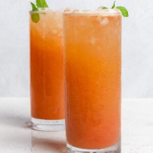 completed Strawberry Pineapple Mocktail in two glasses against a white surface