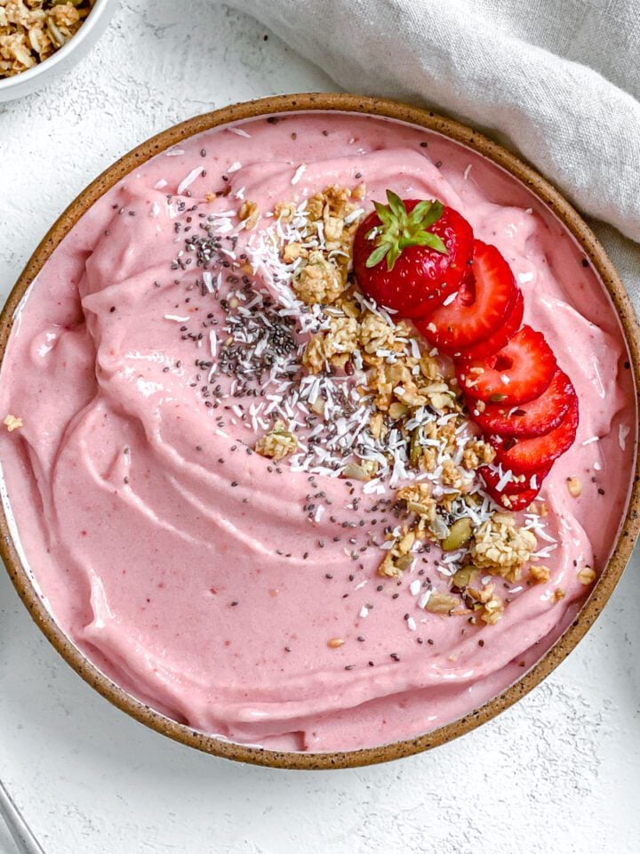 completed Strawberry Smoothie Bowl against a white surface