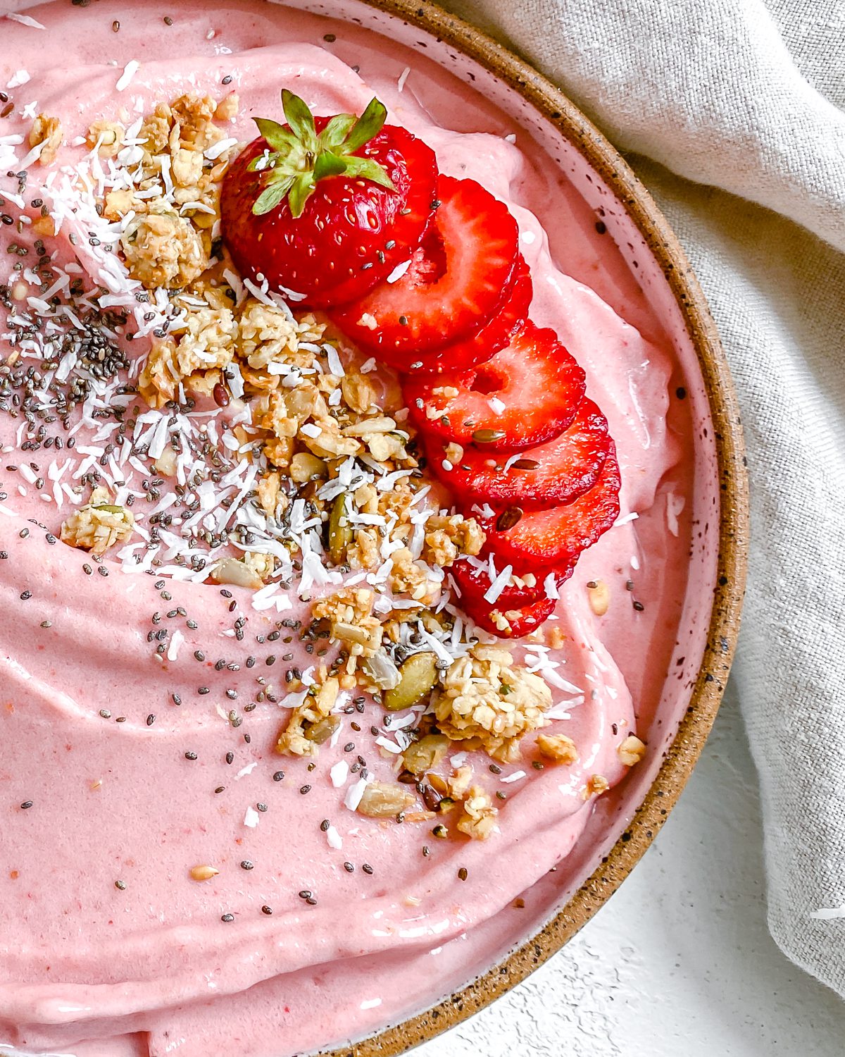 completed Strawberry Smoothie Bowl against a white surface