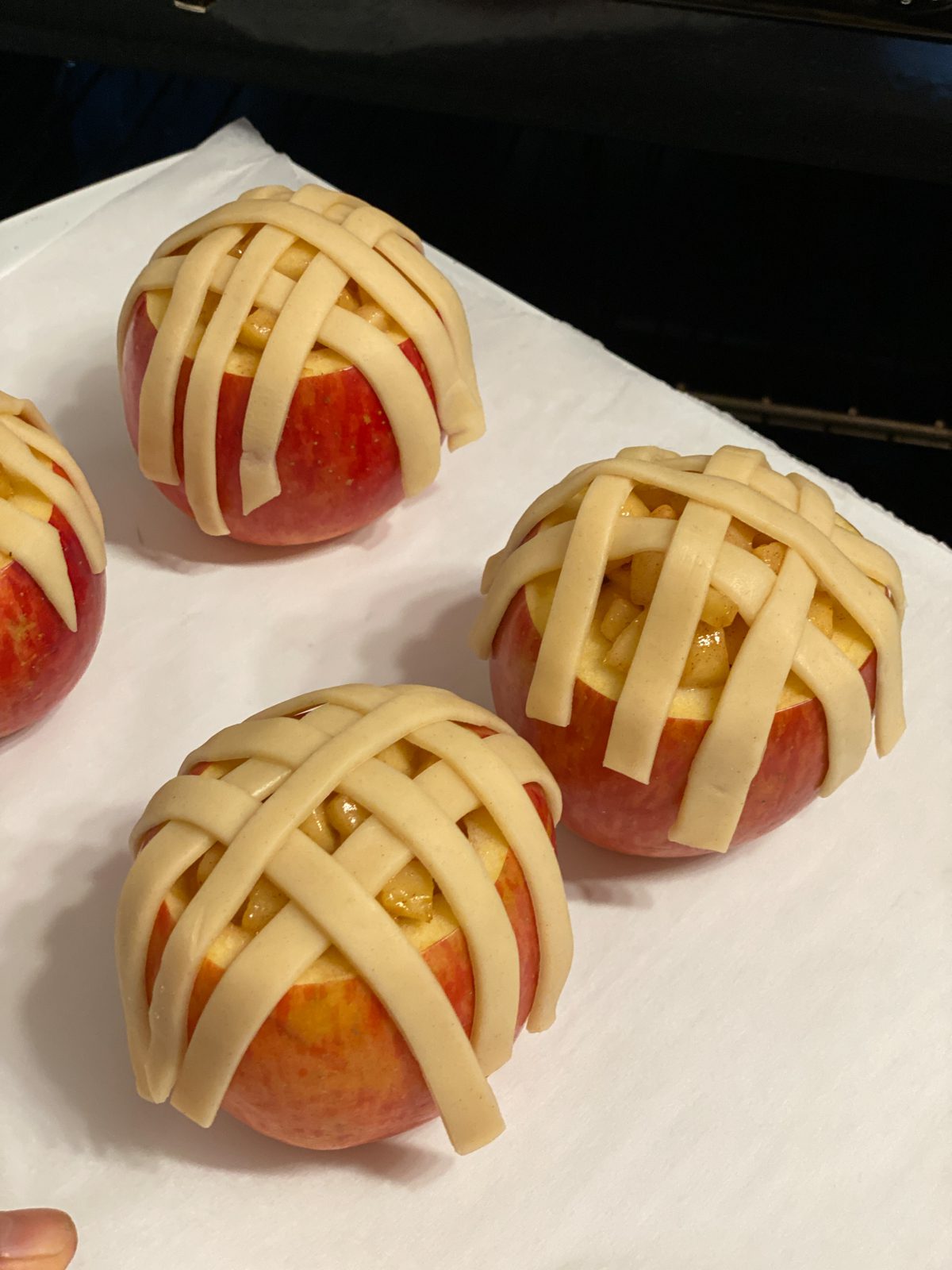 post putting strips of pie crust on unbaked apple