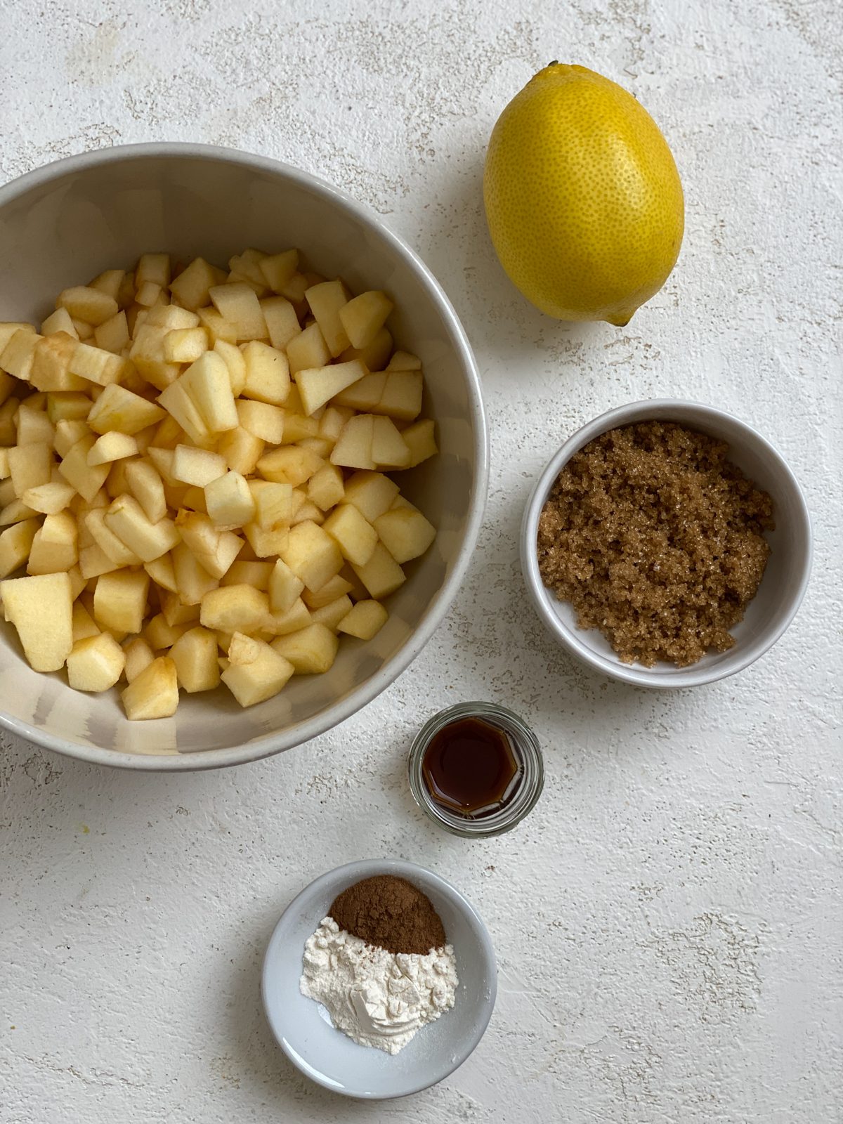 ingredients for Vegan Apple Pie Baked Apples measured out on a white surface