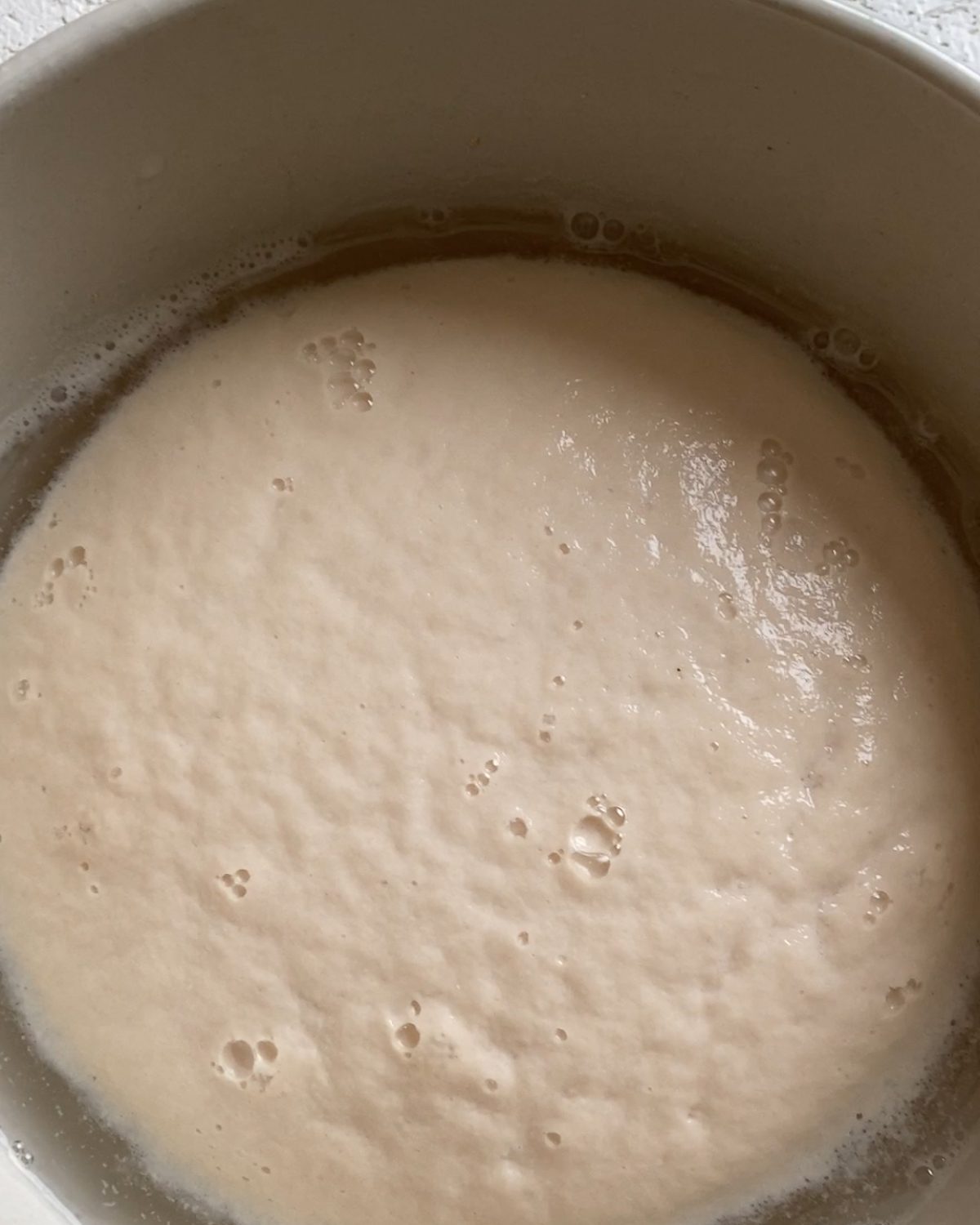 process of yeast mixture rising with bubbles at the surface