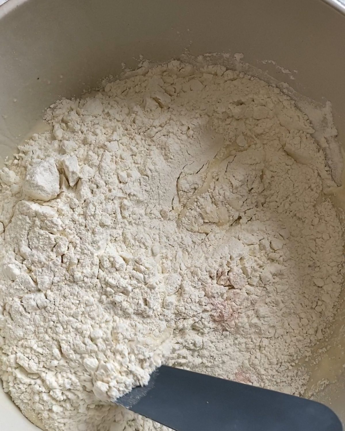 process of mixing flour and herb ingredients together in white bowl