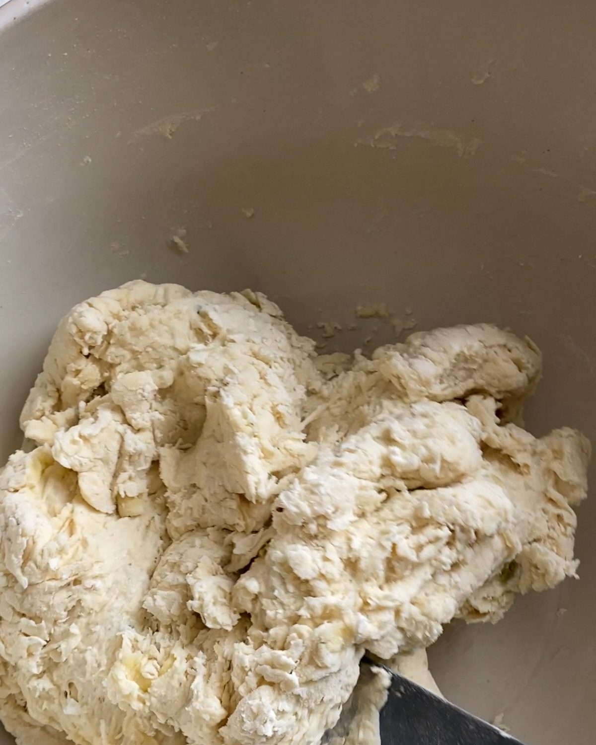 process of forming dough from flour mixture in bowl