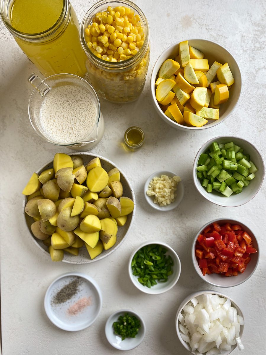 ingredients for Vegan Corn Chowder measured out against a white surface