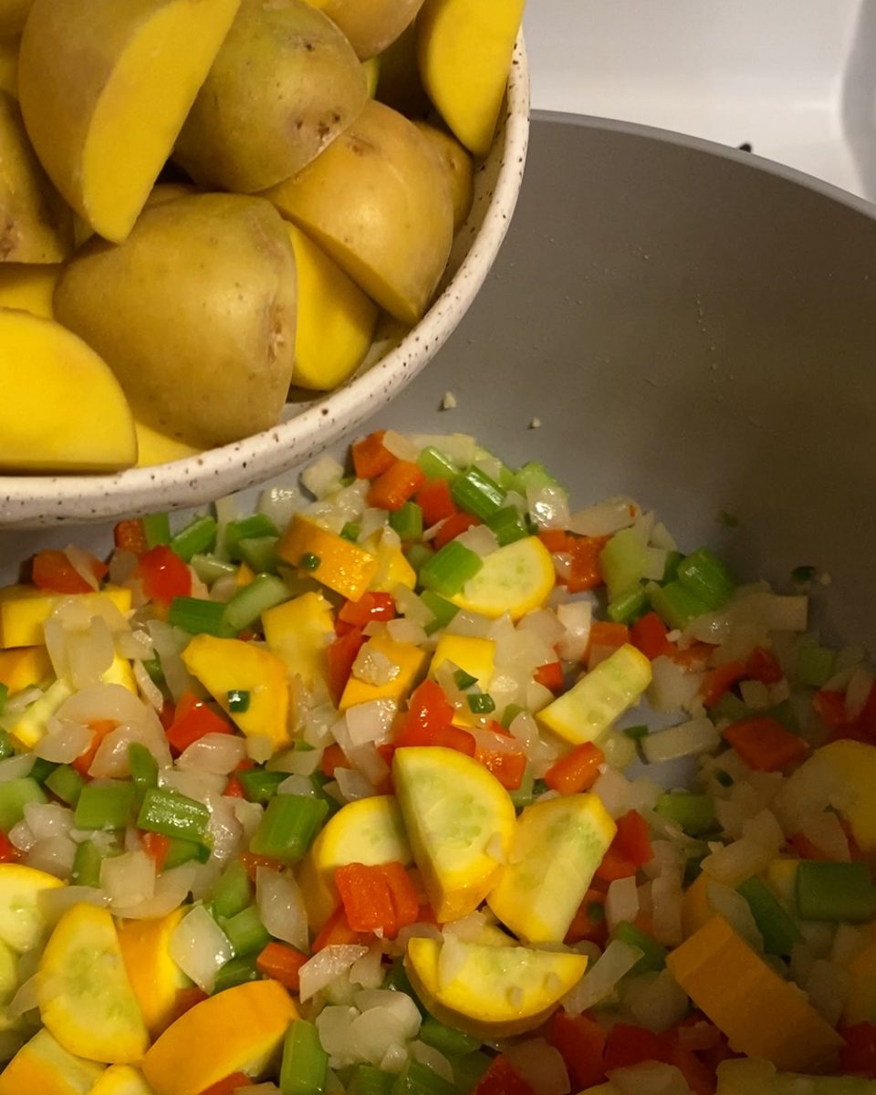 process of adding potatoes to a pan