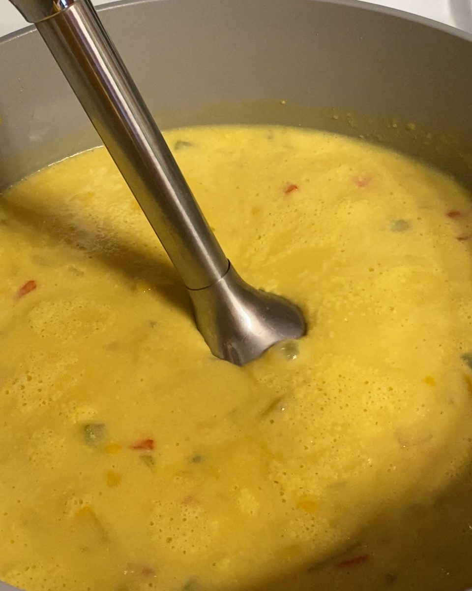 process of using immersion blender in chowder mixture in pan