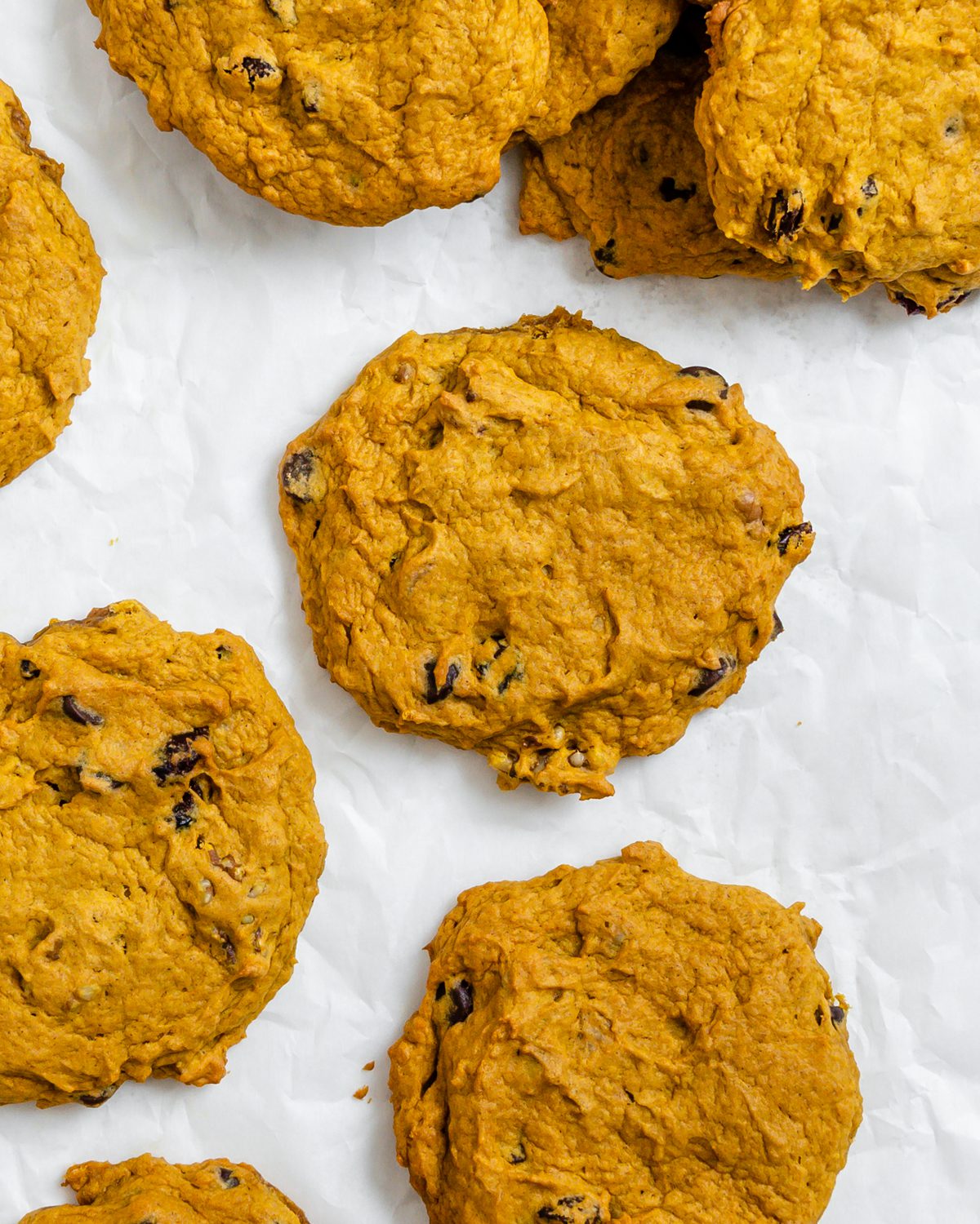 completed Soft Gluten-Free Pumpkin Cookies scattered on a white surface